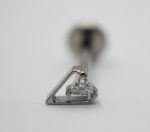 Close-up of a triangular diamond cluster set in a small white-gold triangular stud with blurred screw-back behind.
