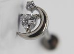 Silver crescent moon stud with a heart-shaped clear gemstone and a small round crystal set above.