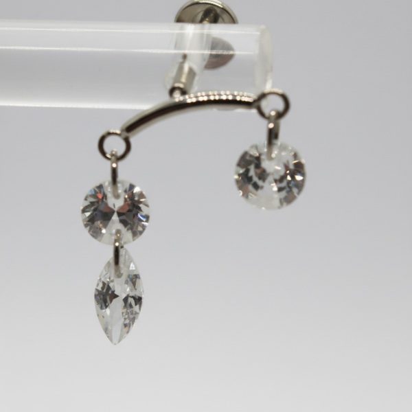 Silver curved jewelry bar with two dangling clear faceted crystals: one round and one round with a marquise-shaped drop