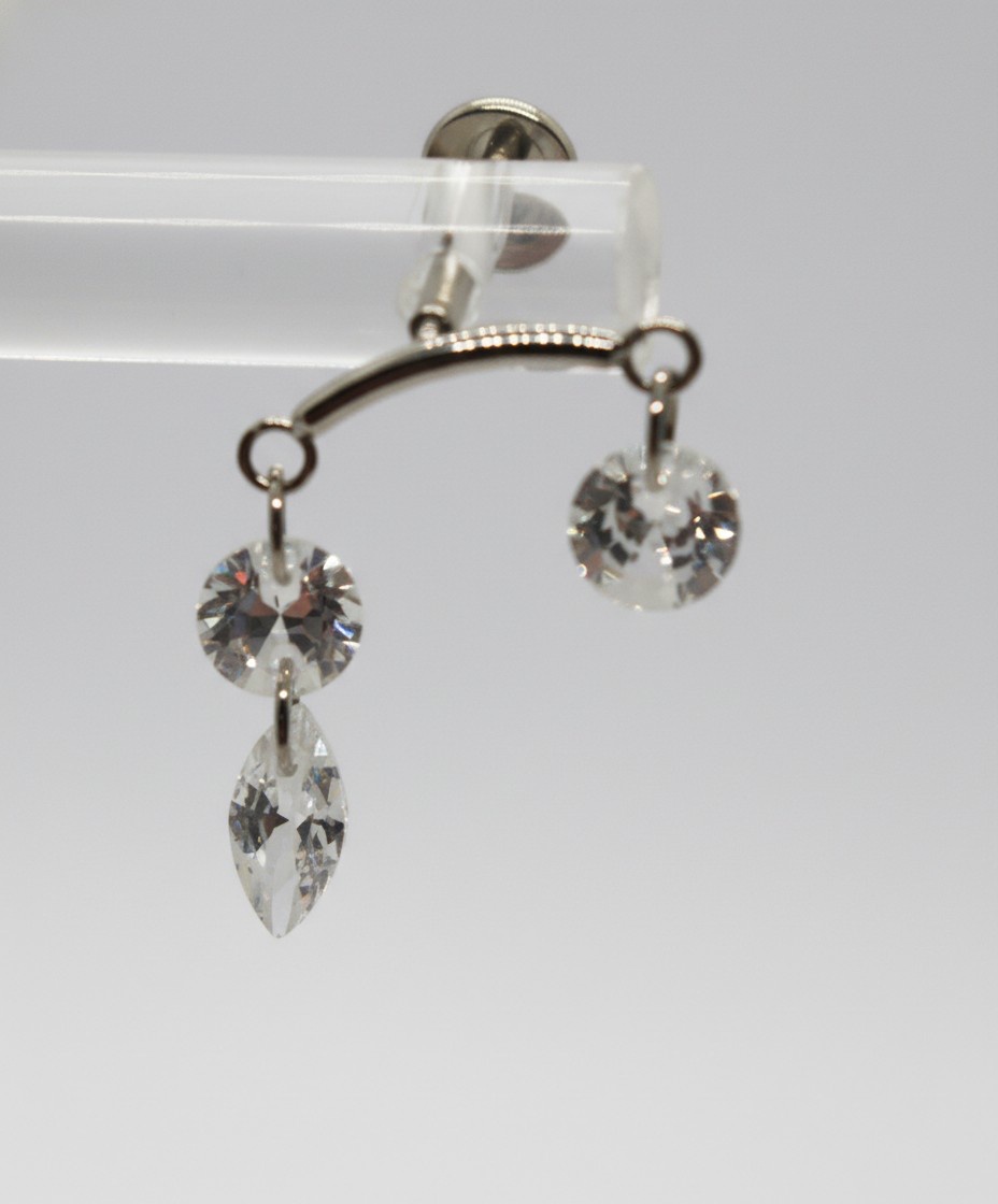Silver curved jewelry bar with two dangling clear faceted crystals: one round and one round with a marquise-shaped drop