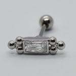 Silver barbell piercing with a rectangular clear gem flanked by small metal spheres on a white background.
