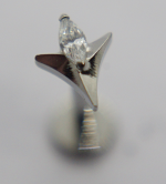 Close-up of a silver star-shaped stud earring holding a marquise-cut clear gemstone at its center.