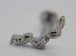 Close-up of a silver leaf-shaped earring stud set with two small round clear gemstones on a white background.