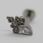 Silver jewelry stud with three bezel-set round crystals, a marquise-cut crystal, and a small cluster of metal beads.