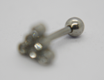 Silver barbell earring with a shiny spherical end and a blurred cluster of small gems on a white background.