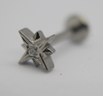 Small silver star-shaped stud earring with a tiny central gem photographed close-up on a white background.