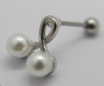 Silver stud earring with two small round white pearls joined by a curved metal loop resting on a white surface.