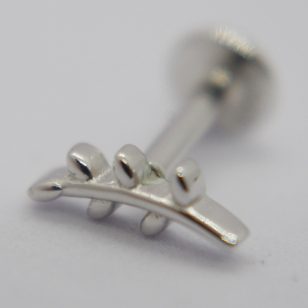 Small silver ear stud with three raised teardrop leaf shapes on a curved bar, shown in macro on a white background.