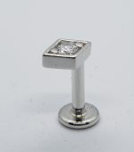 Stainless steel ear stud with square bezel and clear round gem, straight post and flat circular back on white background.