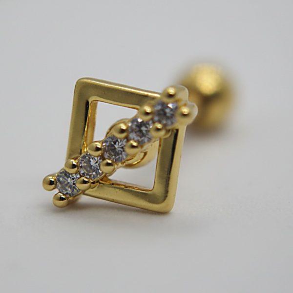 Gold stud earring with an open square frame and five small round clear gems set diagonally, close-up on a light background.