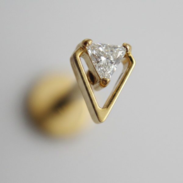 Gold open-frame triangular stud holding a small trillion-cut diamond against a soft gray background.