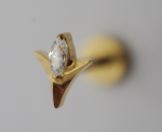 Gold stud earring shaped like a star with a marquise-cut clear gemstone, close-up on a neutral blurred background.