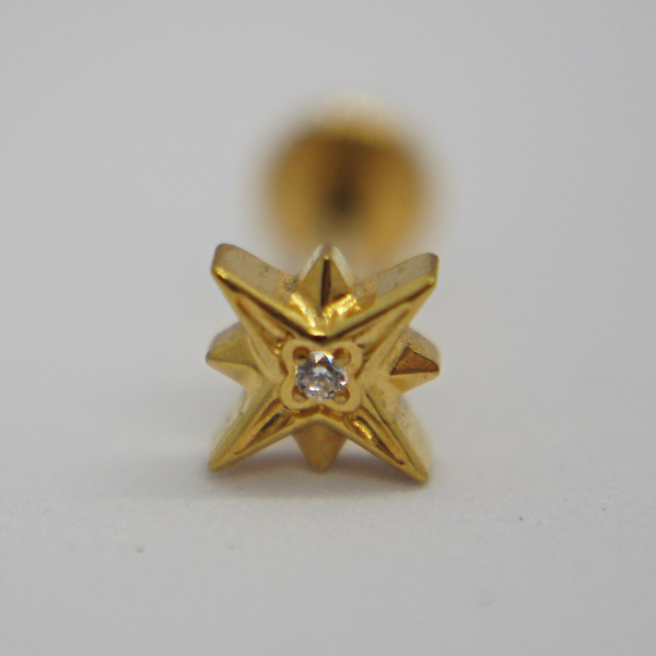 Gold star-shaped stud earring with a small central diamond resting on a white background.