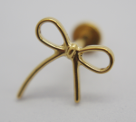 Small polished gold bow-shaped stud earring with looped ribbon design and visible post on soft blurred background.