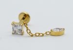Gold stud earring featuring a square-cut clear gemstone and a round bezel-set clear gem linked by a short gold chain.