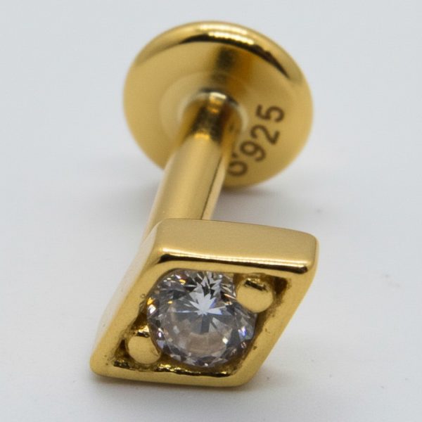 Gold labret stud with a square bezel holding a round clear gemstone, close-up view showing a "925" stamp on the back.