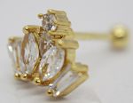 Close-up of a gold stud earring set with marquise, round, and baguette clear gemstones on a white background.