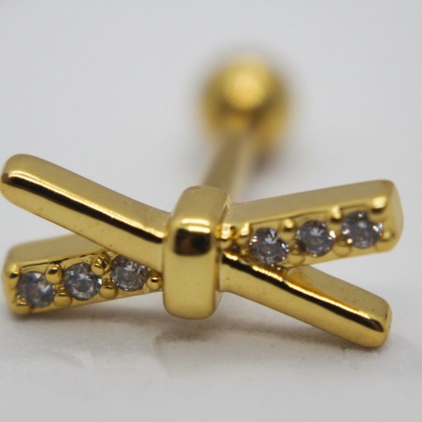 X-shaped gold stud earring with six small clear round stones set along the crossed arms, shown with a blurred screwback.