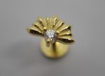 Gold fan-shaped stud earring with radiating petal details and a central clear round gemstone on a gray background.
