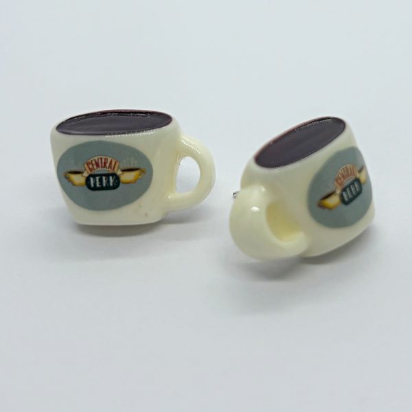 Two miniature cream-colored coffee cups with dark brown tops and Central Perk logos on a white background.