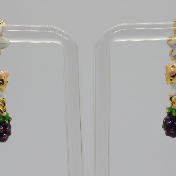 Pair of dangling enamel earrings with white mouse charms, purple flower studs, and blackberry pendants on a clear display.