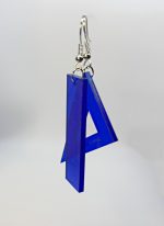 Translucent blue acrylic triangle and bar earrings hanging from silver fishhook wires.