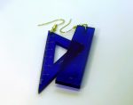 Two translucent blue plastic ruler and triangle-shaped earrings with gold hooks overlapping on a white surface.