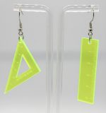 Neon yellow acrylic dangle earrings on a clear stand—one triangular set square and one straight ruler.
