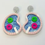 Pair of whimsical pool-shaped dangle earrings with blue water print, pink striped rim, glitter studs, and neon float rings.