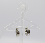 Clear plastic miniature hanger displaying a pair of small silver hoop earrings against a white background.