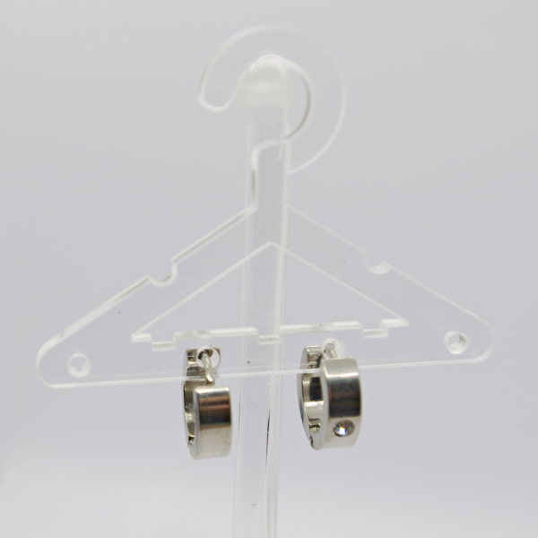 Clear plastic miniature hanger displaying a pair of small silver hoop earrings against a white background.