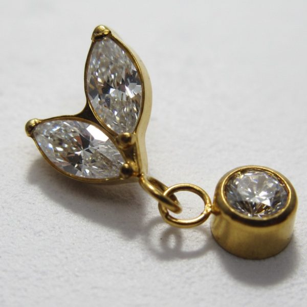 Gold jewelry charm with two marquise-cut clear stones arranged like leaves and a small round bezel-set clear stone