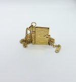 Gold book-shaped locket pendant on a delicate chain, engraved "For all those who found themselves in books."