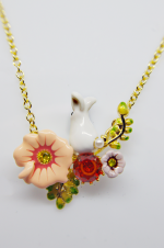 Gold-chain pendant with a small white rabbit amid enamel flowers, a peach blossom, red gem and green leaves.