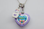 Purple heart pendant with blue center reading HAPPY in rainbow letters, pink bow and white bunny charm on silver chain