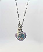 Silver chain necklace with a pastel heart pendant showing a small white bunny, pink bow and tiny star charm.