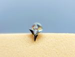 Close-up of a sparkling diamond stud earring on skin