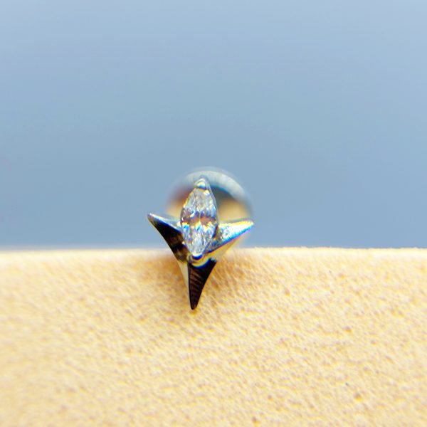 Close-up of a sparkling diamond stud earring on skin
