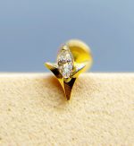 Close-up of a diamond set in a gold ring against a soft blue background