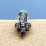 Close-up of a silver and clear gemstone nose stud on skin