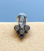 Close-up of a silver and clear gemstone nose stud on skin