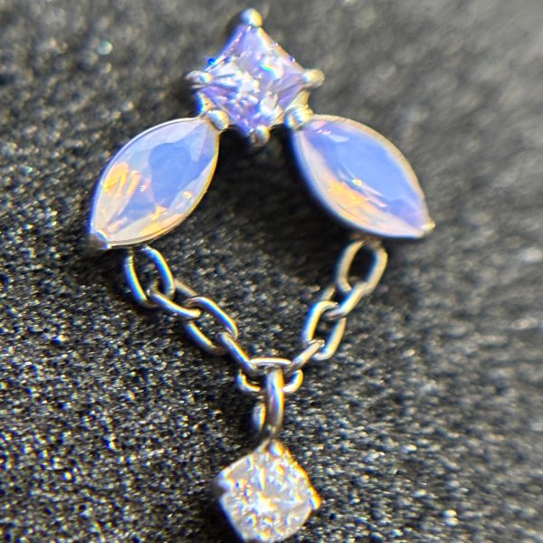 Gemstone ear cuff with two marquise stones and a dangling square crystal on a chain